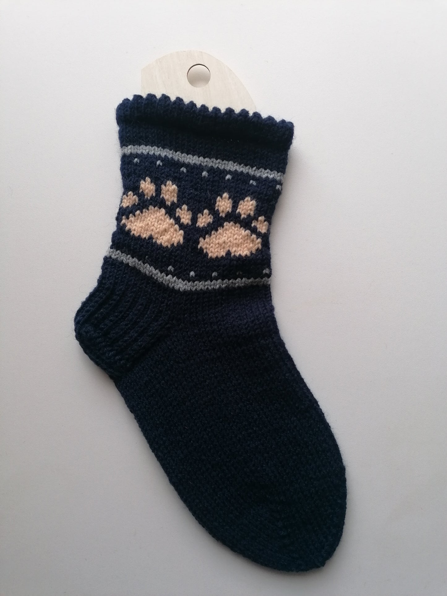 Navy blue sock with a pattern on a white background