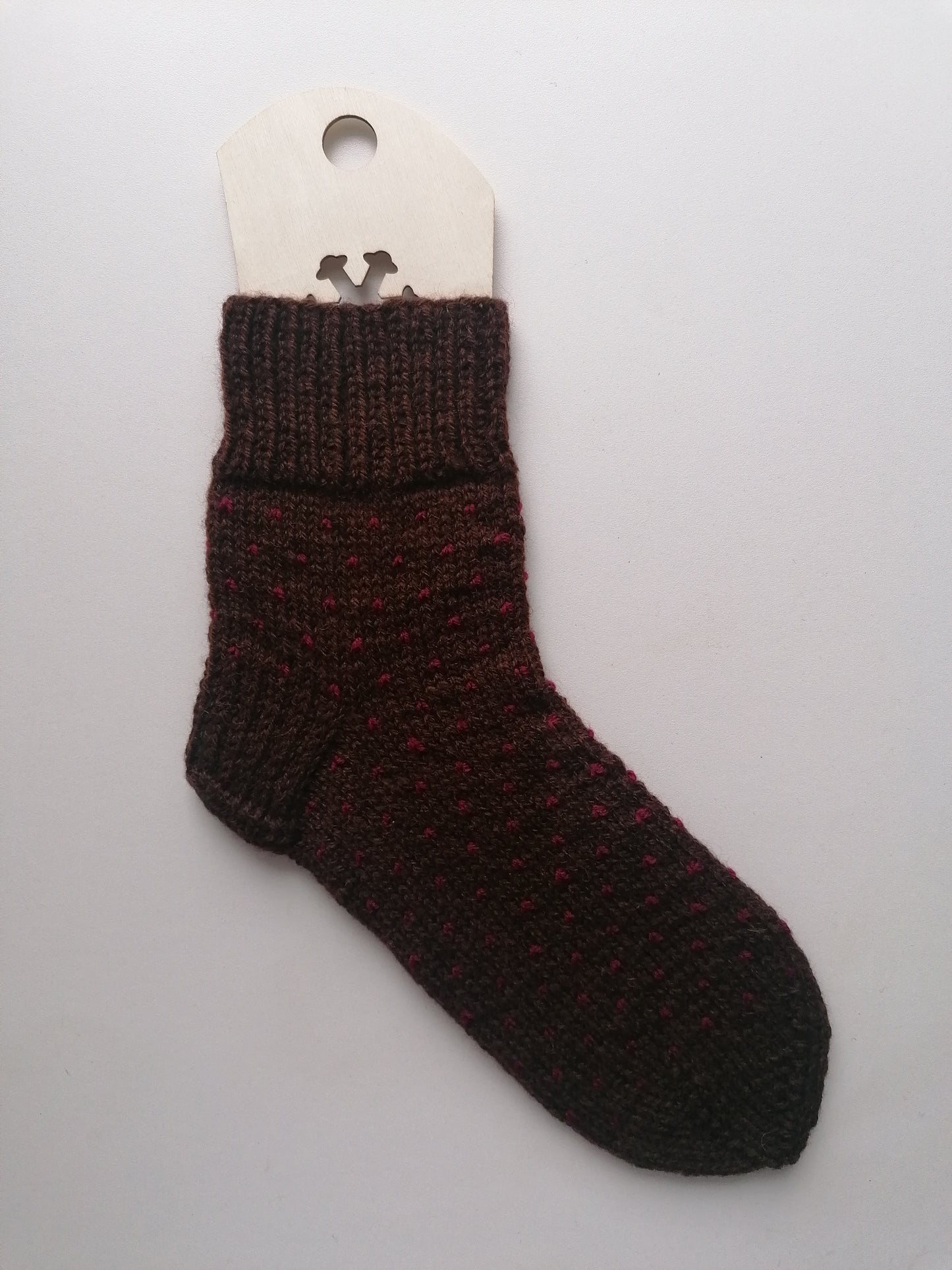 Brown knitted sock on a white background