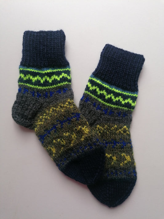 Pair of hand-knitted socks with a pattern on a white background