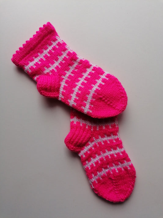Pair of pink socks with white stripes on a light gray background
