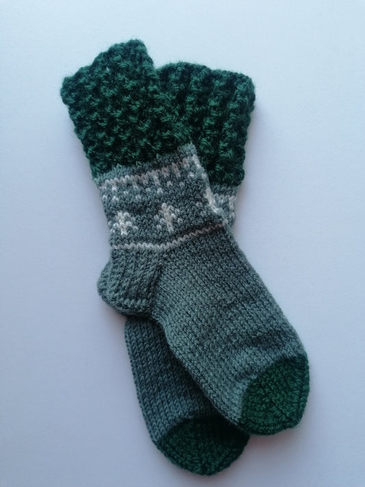 Knitted green socks with a pattern on a white background