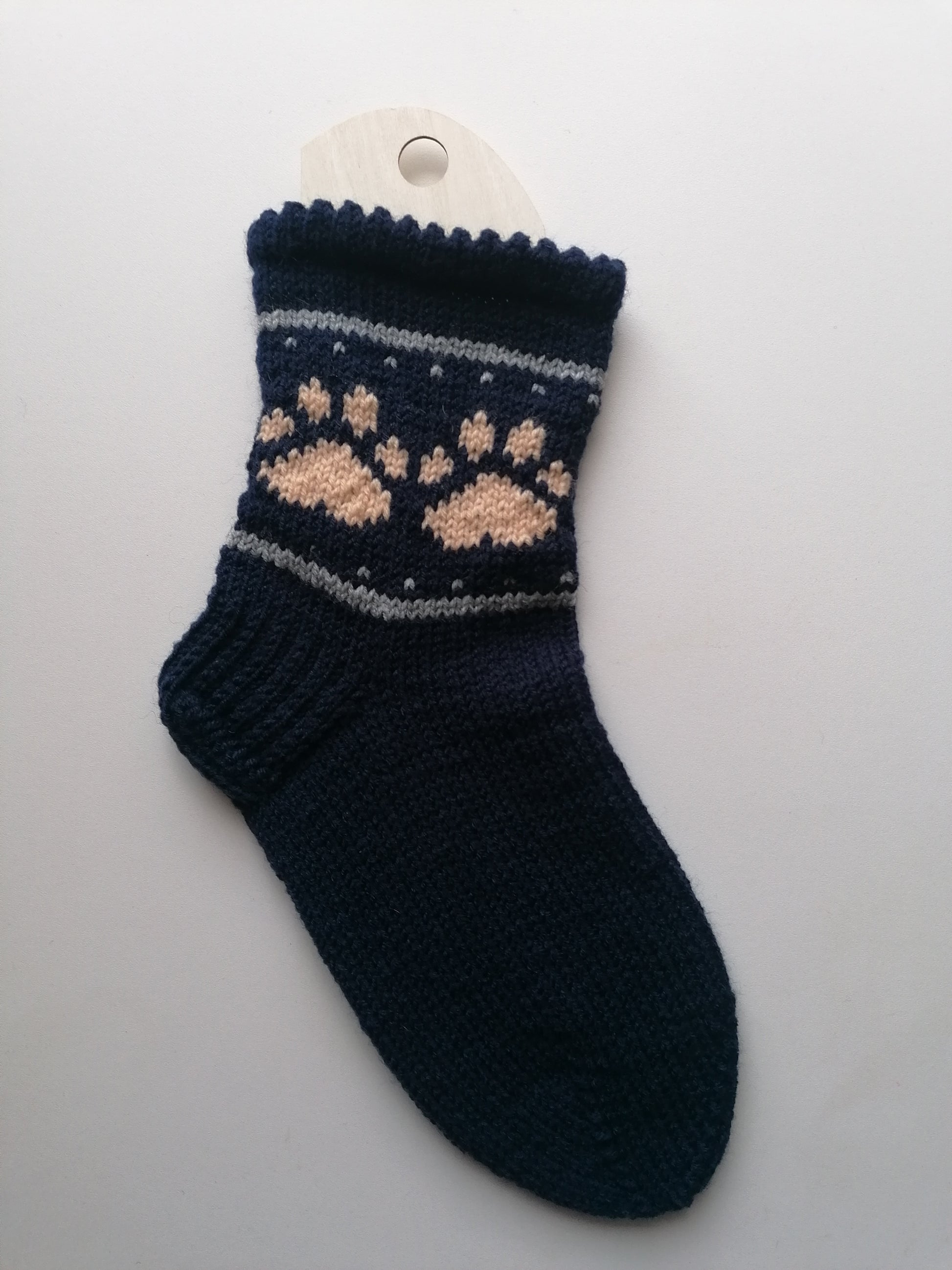 Navy blue sock with a pattern on a white background