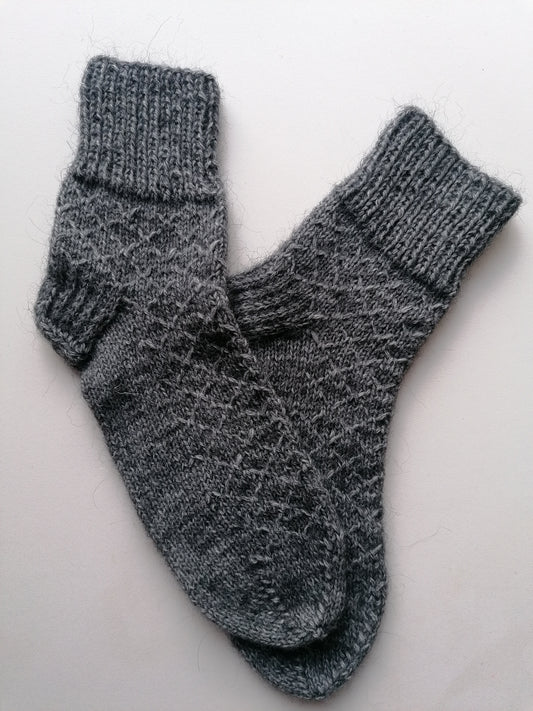 Pair of gray knitted socks on a white background