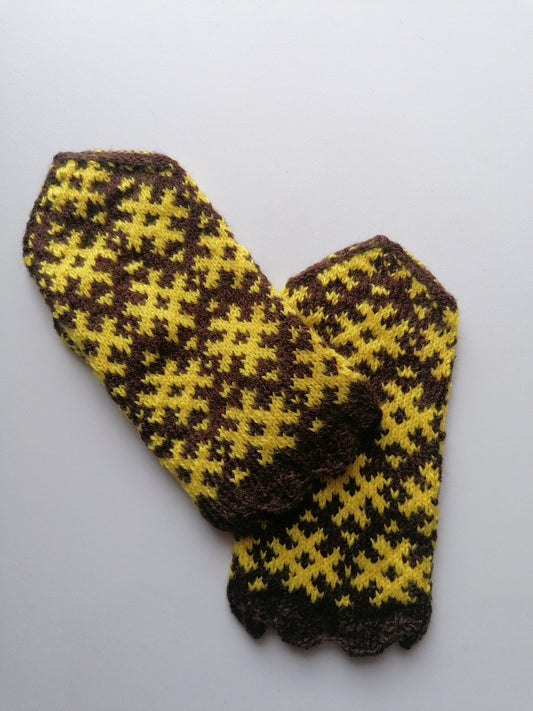 Knitted mittens with a brown and yellow gingham pattern on a light gray background