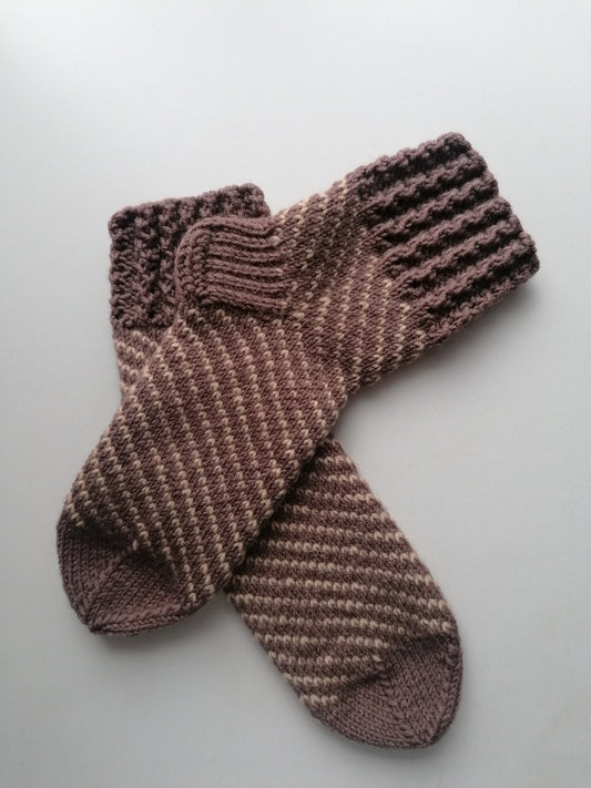 Pair of knitted socks on a light gray background