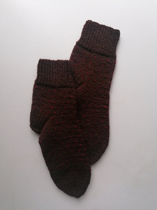 Pair of brown knitted socks on a white background
