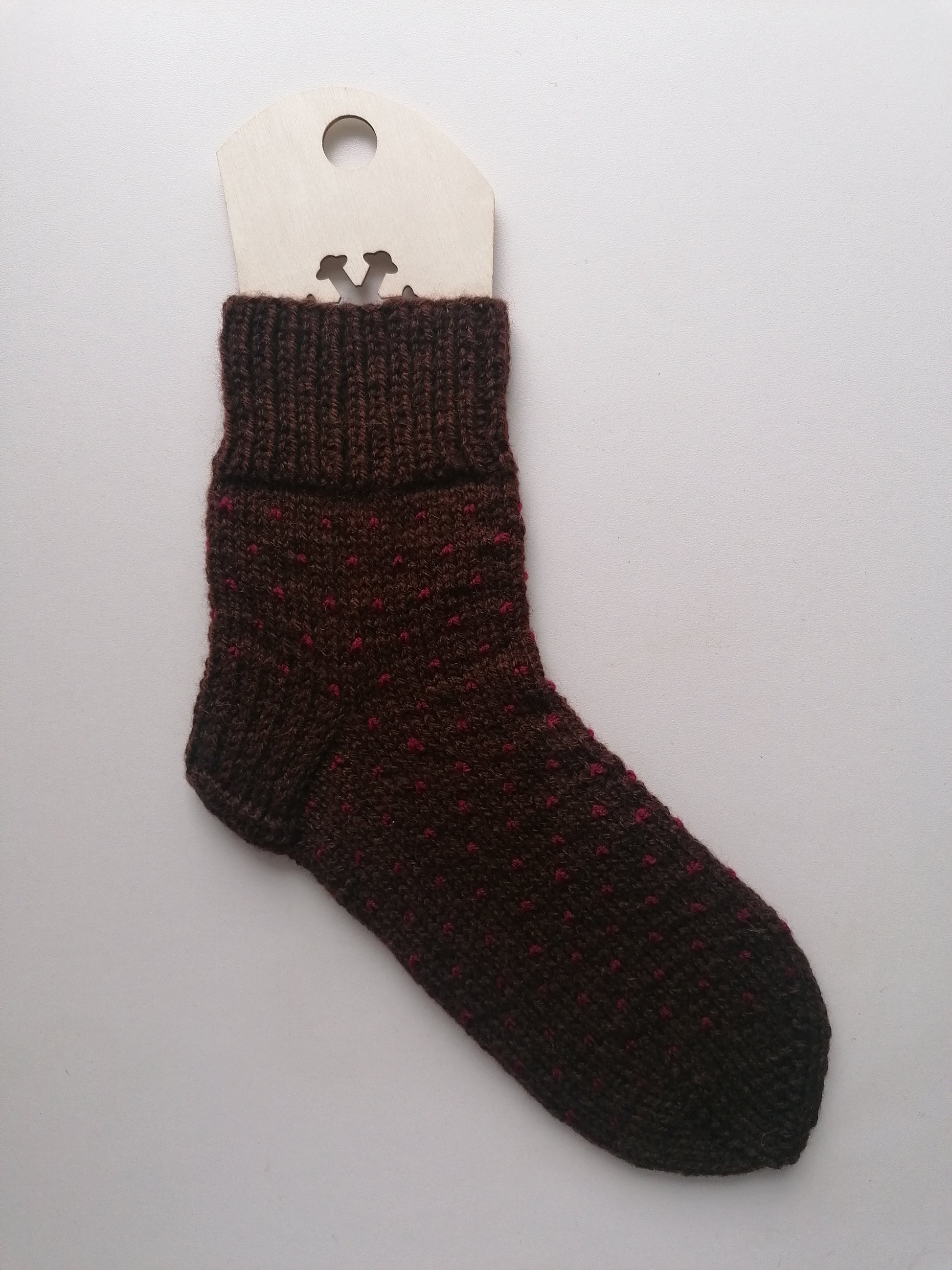 Brown knitted sock on a white background